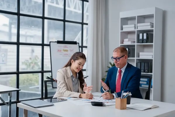 Younger boss speaking to an older employee