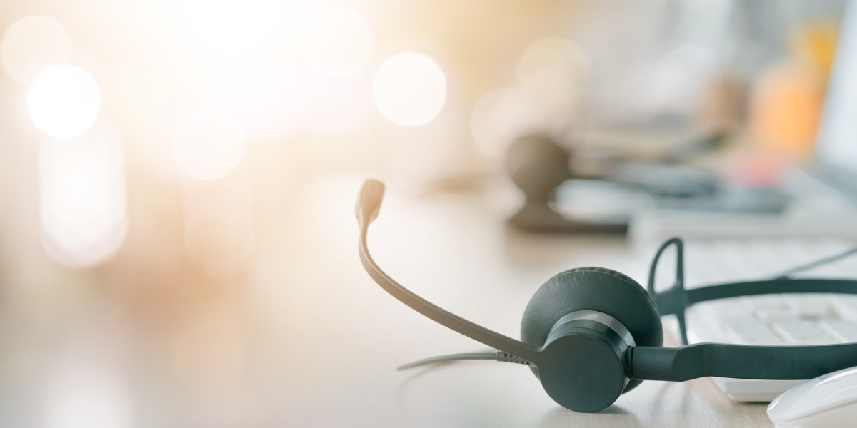 call-center-empty-workstation-with-headphones